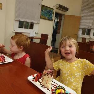duas crianças sentadas numa mesa com um pedaço de bolo em Quality Hotel Regent Rockhampton em Rockhampton
