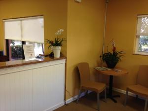 a waiting room with a table and chairs and a window at Surfsider Resort - A Timeshare Resort in Pompano Beach