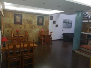 a dining room with tables and chairs and a couch at La Casona Canaria Boutique Home B & B in Agüimes