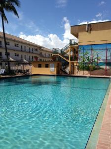 a large swimming pool in front of a building at Surfsider Resort - A Timeshare Resort in Pompano Beach