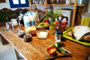 a wooden table with a bunch of food on it at Himara Hostel in Himare