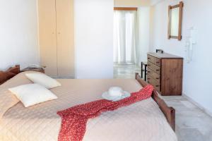 A bed or beds in a room at Gardenia Hotel