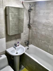 La salle de bains est pourvue d'un lavabo, d'une baignoire et de toilettes. dans l'établissement Loft 2кімнатні Апартаменти Сучасний ремонт WiFi, à Tchernihiv