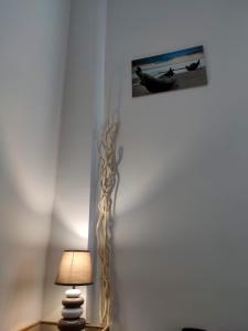 a lamp on a table with a picture on the wall at A Casa Mia in Giffoni Valle Piana