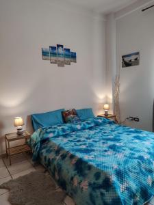 a bedroom with a bed with a blue comforter at A Casa Mia in Giffoni Valle Piana