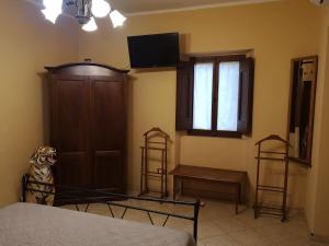 a bedroom with a bed and a wooden door at Guest house le grazie in Orte