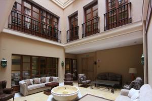 a large living room with couches and chairs at Casa Consistorial in Fuengirola