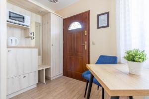 a room with a table and a wooden door at Mewa in Sztutowo