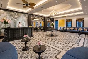 a hotel lobby with a woman in the background at Ha Long Essence Hotel in Ha Long