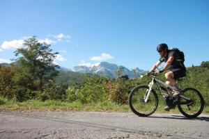 a man riding a bike down a road at Cà Del Moro Resort in Pontremoli