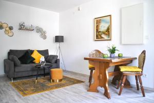 a living room with a table and a couch at Evia Ferienwohnung in Heimbach +23 photos