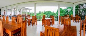 a dining room with wooden tables and chairs at Four Points Resort - Anuradhapura in Anuradhapura