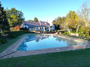 a swimming pool in the yard of a house at Elgin Vintners Country House in Elgin
