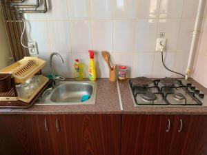a kitchen counter with a sink and a stove at Casa Zmeilor in Tăşnad +27 photos