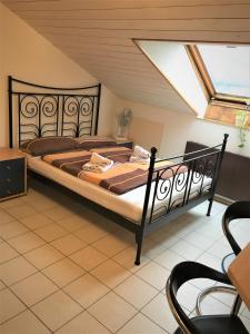 a bedroom with a bed and a skylight at Studentenwohnung in Allensbach