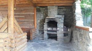 an outdoor brick oven in a log cabin at "Бджілка" in Lyuta