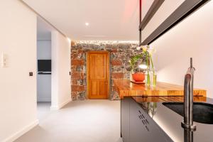 a kitchen with a stone wall and a wooden counter top at Lighthouse on La Palma Island in Barlovento