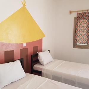 A bed or beds in a room at Le Petit Quartier "Chez Amanthia"