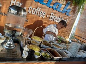 a man preparing a buffet of food at a food stand at SALAH HOTEL in Quy Nhon