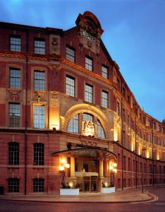 a large red brick building with an arch on it at Malmaison Hotel Leeds in Leeds