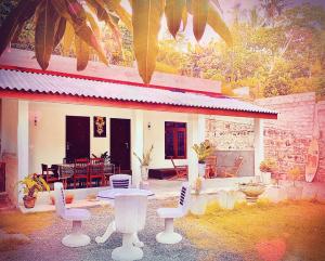 a house with white chairs in front of it at Villa Angel in Hikkaduwa
