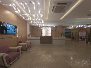 a hospital lobby with chairs and a reception counter at Season Inn Hotel in Barka