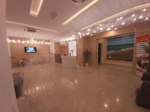 a large room with lights and a large painting on the wall at Season Inn Hotel in Barka