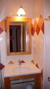 a bathroom with a sink and a mirror at LES MENUIRES REBERTY in Les Menuires +9 photos