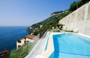 a swimming pool on a hill next to the ocean at Pagliarulo Complex by AMALFIVACATION in Ravello