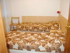 a bedroom with a bed with a blanket on it at Chalet Decrestina in Campitello di Fassa