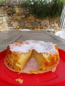 a piece of cake on a red plate on a table at Ort holiday's time in Orco Feglino