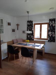uma sala de estar com uma mesa de madeira e cadeiras em Ferienwohnung Valentin em Grossarl
