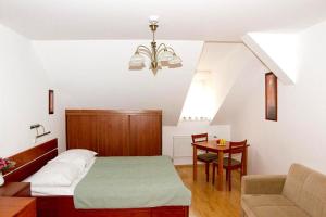 sypialnia z łóżkiem, kanapą i stołem w obiekcie Hotel Dar w Pradze