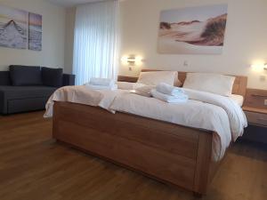 a bedroom with a large bed with two towels on it at Hotel Penterknapp in Bramsche
