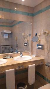 a bathroom with two sinks and a large mirror at Parador de Alcañiz in Alcañiz