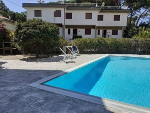 a villa with a swimming pool and a house at VILLA VERDEMARE in Paestum