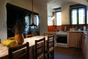 a kitchen with a table with a vase on it at Masoveria del Mas Plaja de Fitor in Palafrugell