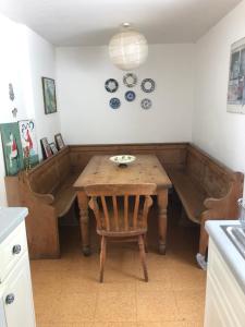 a kitchen with a wooden table in a room at Tremanhire Cottage in Solva