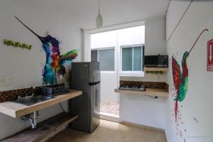 a kitchen with a refrigerator and a sink at Hostal Gayser in Valladolid