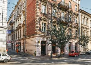 a large brick building on the side of a street at 7 HEAVEN Elegant Rooms KRAKÓW Old Town in Krakow