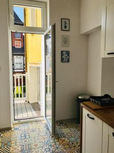 a kitchen with a door leading to a patio at Ahoj Apartments in Ustka