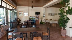 a restaurant with tables and chairs in a room at Anopoli Rooms in Anopoli Sfakion