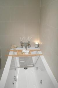 a bathroom with a sink and a bath tub at Ashford house 'The Snug' private hot tub in Fylingthorpe
