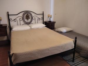a bedroom with a large bed and two night stands at Casa do Outeiro in Penacova