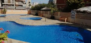 a large pool with blue water in a building at Amatista 110 in Calpe