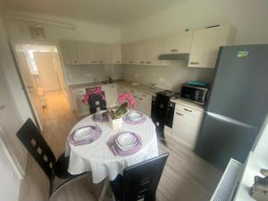 a kitchen with a table with plates and flowers on it at Einfamillienhaus in Rustenfeld