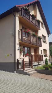 a building with balconies and flower boxes on it at Apartmány 105 in Habovka