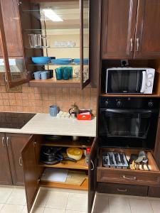 a kitchen with a stove and a microwave at City Comfort Rooms in Larnaka +15 photos