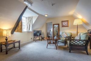 a living room filled with furniture and a table at The Talbot Hotel, Oundle , Near Peterborough in Oundle