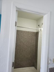 a shower with a glass door in a bathroom at High Desert Inn in Hesperia